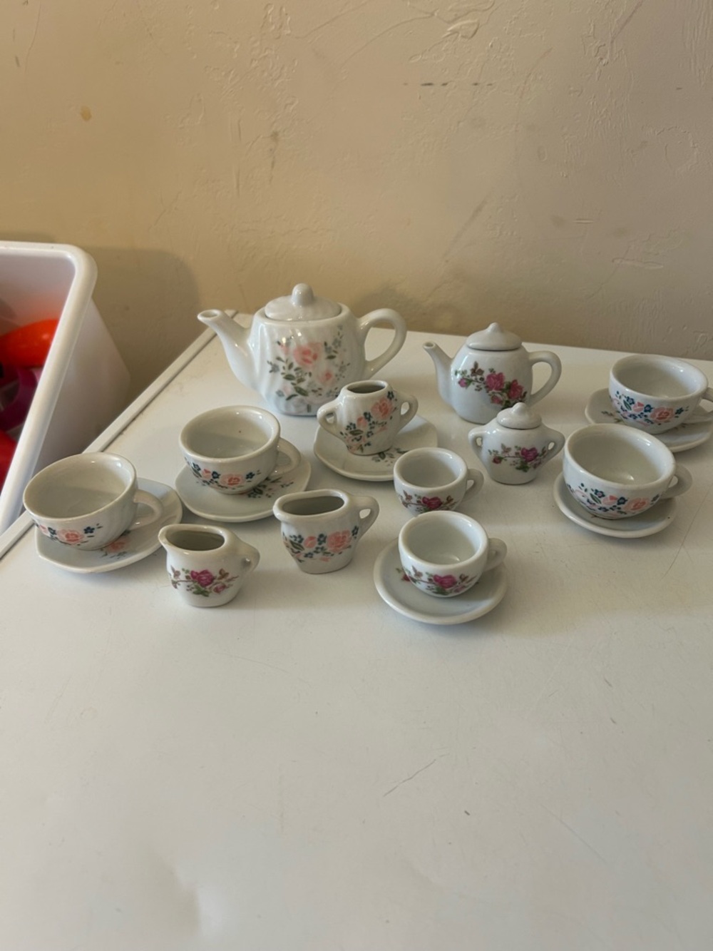 vintage miniature porcelain tea set with tea pot and cups